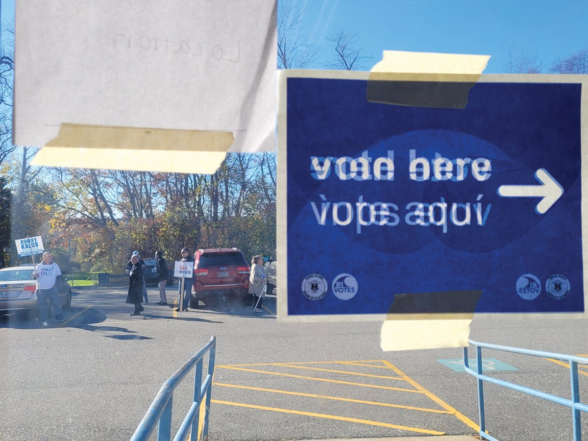 LOOKING OUTWARD: The view from inside the polling place at Ferri Middle School shows campaign supporters in the parking lot.